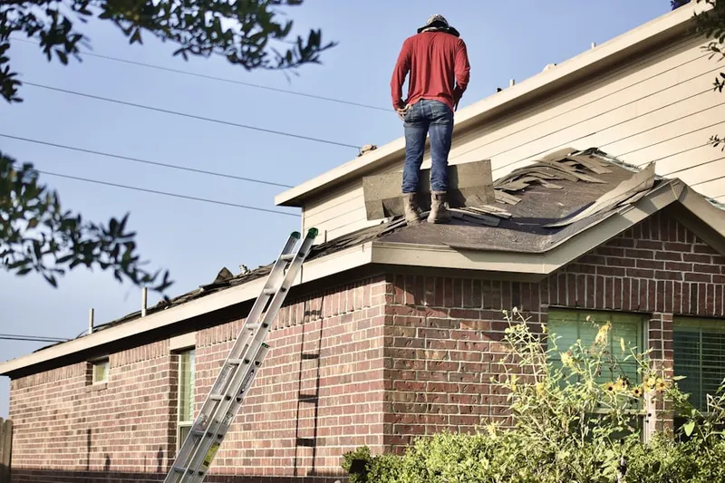 Professional roofer working on a residential roof in Washington Junction